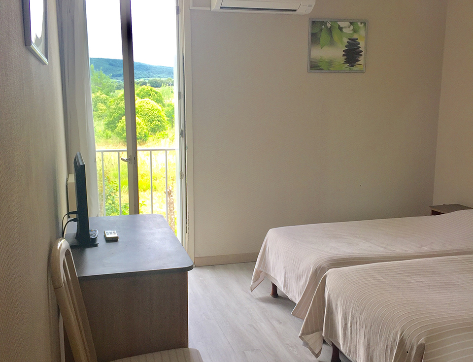 Upstairs north facing bedroom with view across the courtyard/nature, charming hotel and restaurant Saint-Benoit, accommodation Saint Guilhen le désert