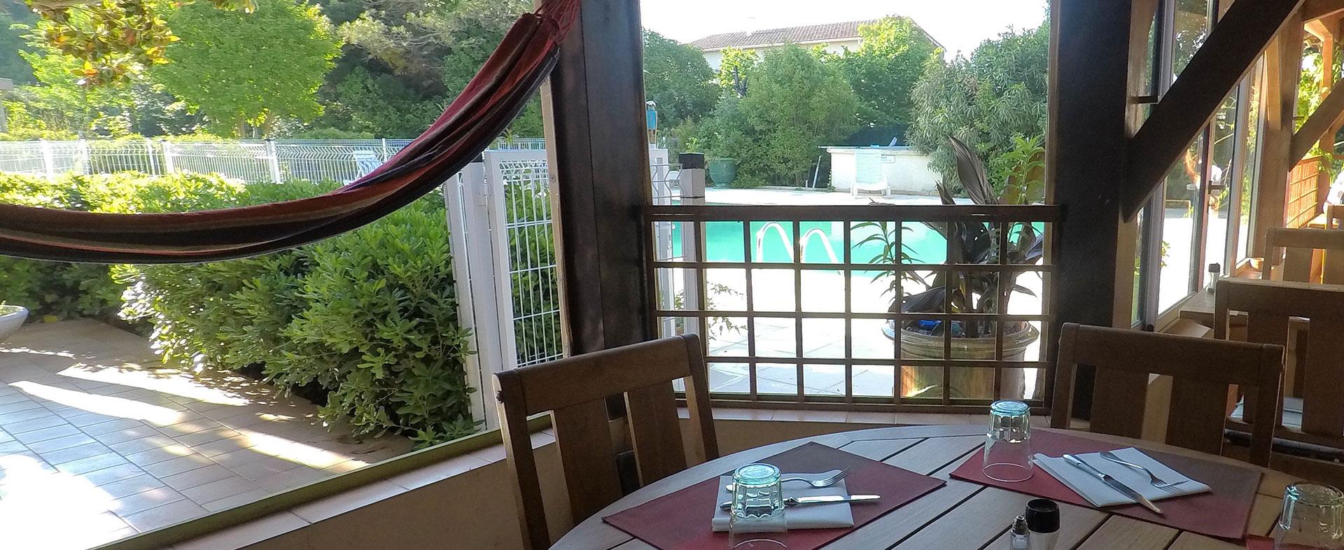 View across the pool from the terrace of the hotel Saint-Benoit in Aniane